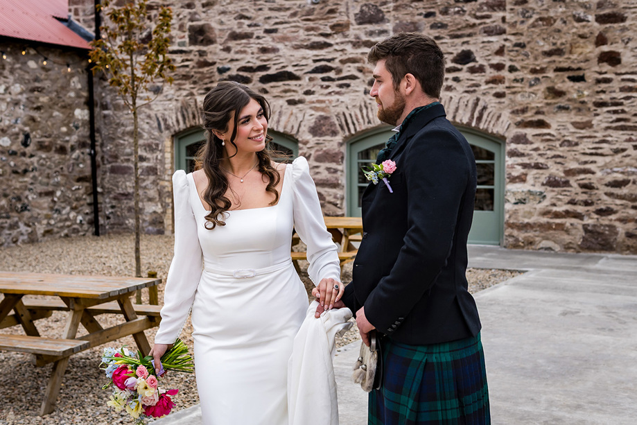 Bride and groom in courtyard of Kinclune Steading
